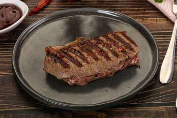 Grilled beef striploin steak with sauce