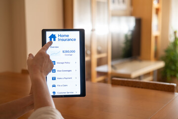 Woman using a digital tablet to manage her home insurance policy, accessing overview, coverage details, payment options, claims, and customer service from the comfort of her home