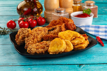 Golden crispy fried chicken mix - wings, drumsticks, nuggets and strips