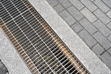 Urban Drainage Grate and Paving Stones. street and sidewalk design for water management and...