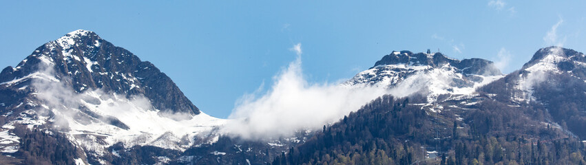 The mountains are covered in snow and the sky is clear