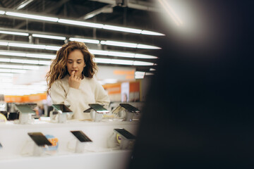 Young Woman Shopping for Electronics in a Bright Modern Store