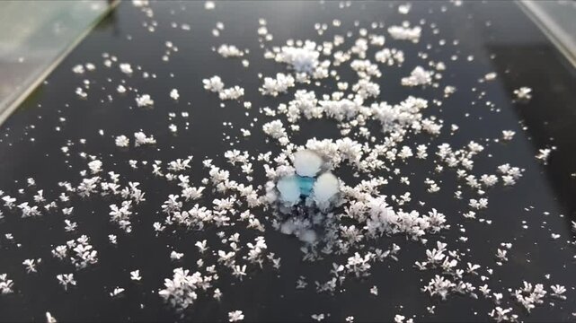 Water drops on window glass with winter holiday snowflake decoration pattern 4k Abstract background video