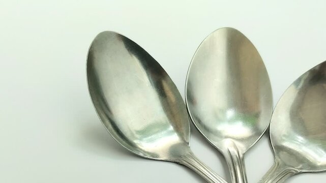 stainless steel spoon on white background. Stainless steel spoons are a safe and popular choice for eating or cooking utensils because they are rust and corrosion resistant.