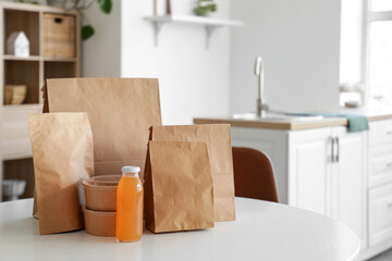 Paper bags with juice on table in room. Food delivery service
