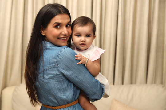 Close up of happy young indian mother hug cuddle little infant or toddle. motherhood, childcare concept. Concept : Happy Mothers Day