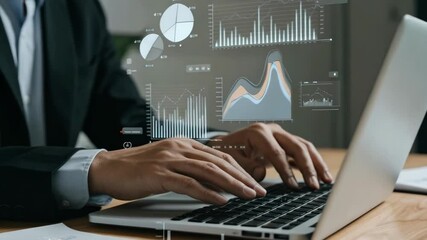 Businessman working on laptop with digital charts and graphs overlay - Powered by Adobe