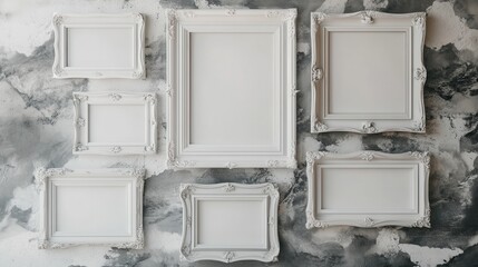Seven ornate white frames on a gray marbled wall, empty for customization. Ideal for showcasing your art, photos, or adding a personalized touch.