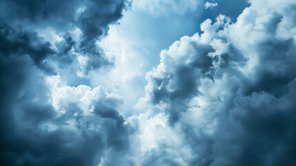 Obraz premium Dramatic storm clouds in deep blue, a sweeping skyscape with dynamic light, nature's raw power on display 