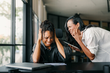 Workplace aggression, stressful work environment. Angry boss shouting at the worker in the office