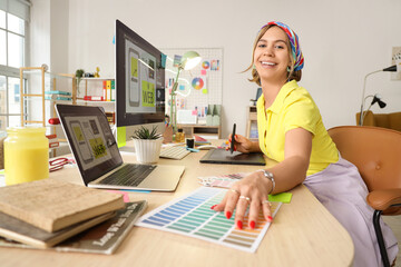 Beautiful web designer working at table in office