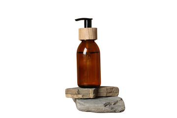 Amber bottle resting on two stacked stones, isolated on white, PNG