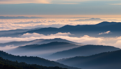 Obraz premium Vast layered terrain cloaked in mist with soft light and peaceful atmosphere at sunrise