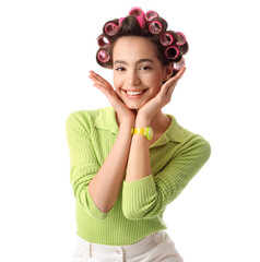 Young woman with hair curlers on white background