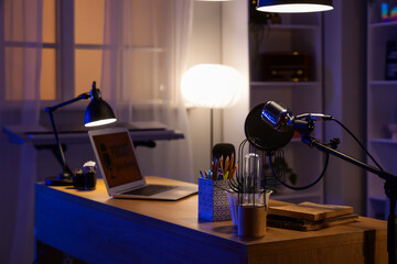 Stand with professional microphone in dark podcaster's studio, closeup