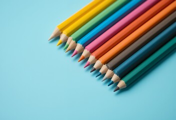 Fototapeta premium Arrangement of colorful sharpened pencils on blue background showing creativity and art tools