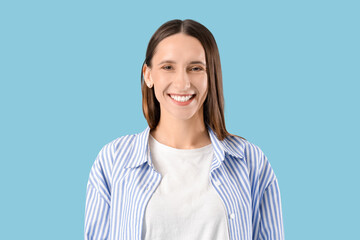 Young woman with beautiful smile on blue background