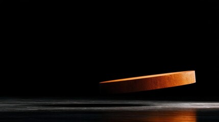 Close-up of an orange-colored object that appears to be floating in the air. the object is in the center of the image, with a black background.