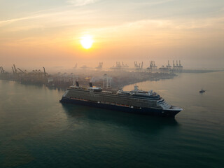 luxury cruise ship for first class passenger is sailing in of the port, at morning aerial view