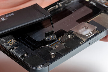 The smartphone was damages and need to repair  which tools smartphone that stand on white background by hands of repairman.

