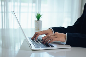 An investor monitors real-time stock market data on a smartphone and laptop, analyzing charts,...