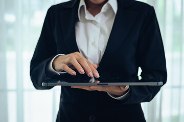 A professional businessman analyzes financial charts and stock market data on a digital tablet, focusing on investment strategy, economic growth, and global market trends for success.