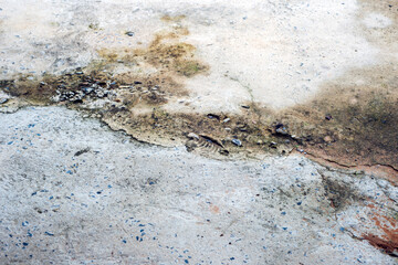 Traces of time left on the old concrete background, faded walls, accumulated with mold.