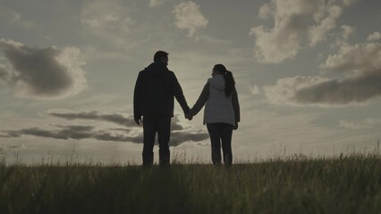 silhouette man and woman at sunset, hold partner's hand sun, teamwork, corporate happy farming group, successful business team, trust of successful people, joy of joining unity, raise your hands up.
