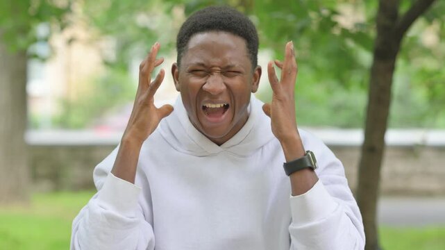 Angry African Man Screaming and Shouting Outdoors, Portrait