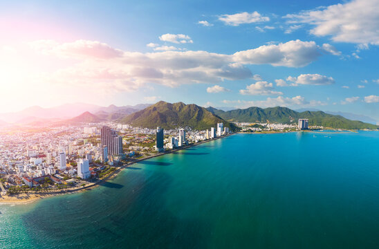 Beach overlooking panorama aerial view city on the coast of Southeast Asia in the evening at dawn sunset Nha Trang