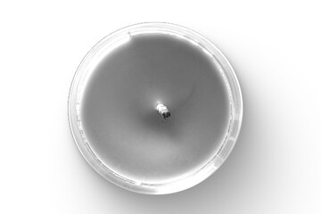A top-down view of a lit candle in a clear container, creating a calming ambiance.