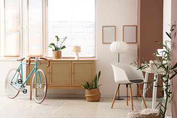 Interior of home office with workplace, bicycle and commode
