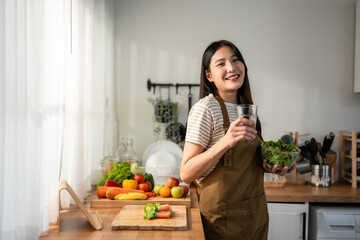 Portrait of Asian woman eating healthy salad and drink clean water. 