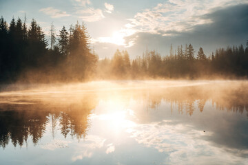 Fototapeta premium Serene Awakening - A Golden Sunrise Paints the Tranquil Lake in Warm Hues