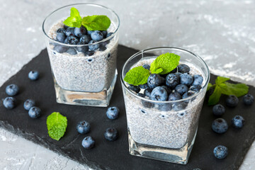 Healthy breakfast or morning with chia seeds vanilla pudding and blueberry berries on table...