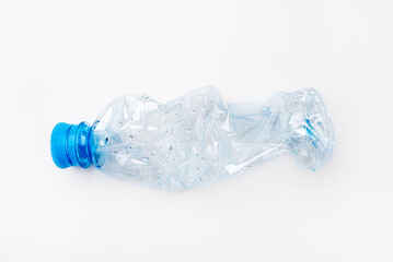 Crumpled empty plastic bottle on a white background