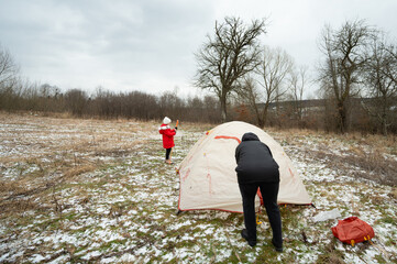 On a brisk day filled with outdoor adventure, we find ourselves setting up a warm and inviting tent in the midst of a snow covered meadow, enjoying quality time with family