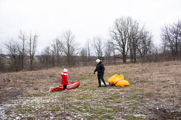 Family bonding while preparing colorful kites in a winter field, capturing the essence of outdoor fun and creativity