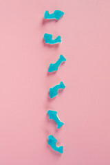 Jelly fish candies. Gummy shark, blue dolphin jelly coated with sugar on a pink background. © apinya