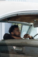 Man seating in the vintage car