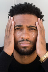 Man with glitter tears looking at camera