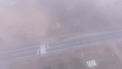 Overhead shot foggy highway surrounded by trees