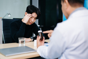 Asian man visiting psychiatrist for mental health consultation. Calm, thoughtful moment of therapy and emotional support.