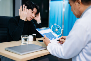 Young Asian man expressing concern in therapy session with psychiatrist. Mental health, stress, support, anxiety,