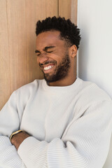 Thoughtful Man Leaning Against a Wall