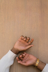 Hands of the man against wooden background