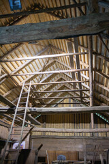 A wooden building with a ladder on the side