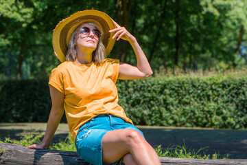 Summer  portrait of a woman in park 30-40 years old. straw hat