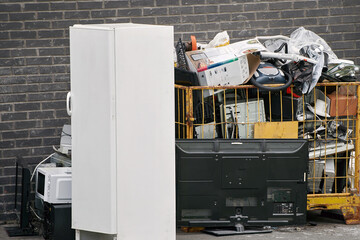 Urban e-waste recycling bin overflowing