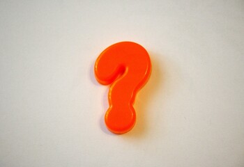 Orange question mark with white background.